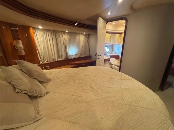 Stella Mia Yacht Photos Pics Luxurious bedroom interior of 2001 Azimut 68 Plus yacht with ensuite bathroom.