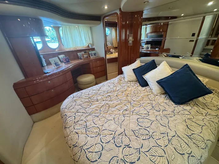 Stella Mia Yacht Photos Pics Luxurious bedroom interior of 2001 Azimut 68 Plus yacht with elegant decor and plush bedding.