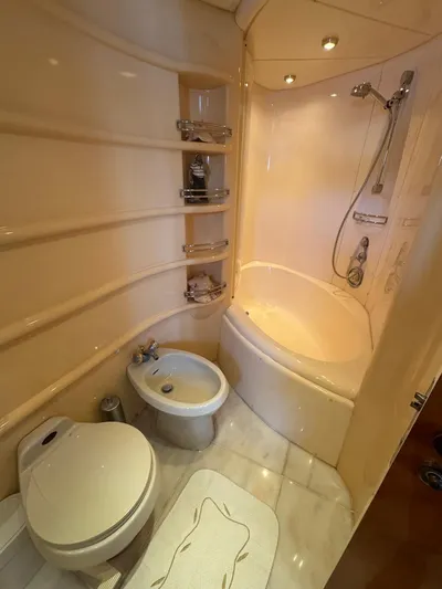 Stella Mia Yacht Photos Pics Luxurious bathroom in 2001 Azimut 68 Plus yacht with shower, toilet, and bidet.
