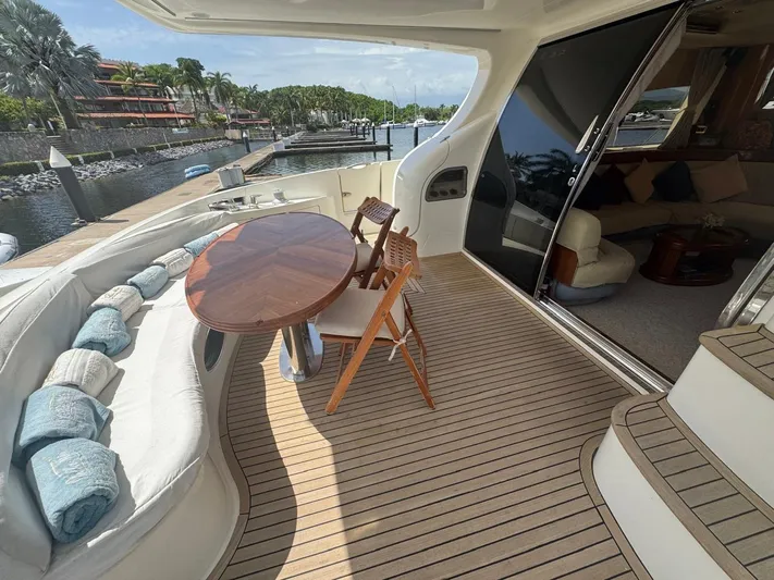 Stella Mia Yacht Photos Pics Luxurious 2001 Azimut 68 Plus yacht deck with seating, table, and marina view.