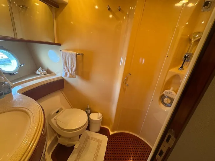 Stella Mia Yacht Photos Pics Luxurious bathroom in 2001 Azimut 68 Plus yacht with shower and porthole window.