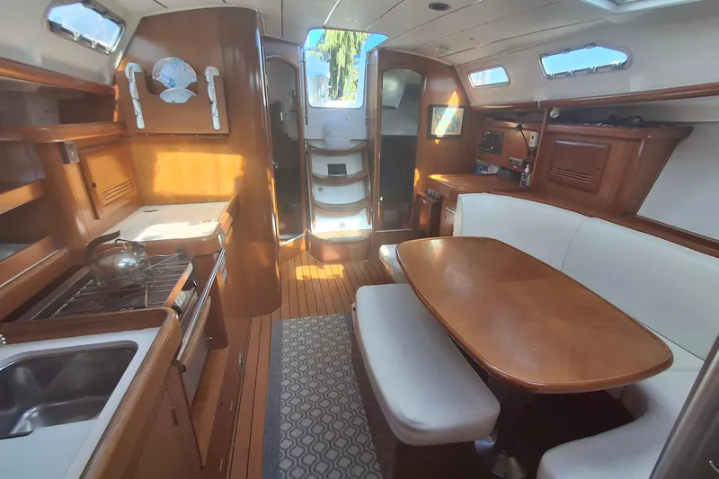 H2o Bungalow Yacht Photos Pics Interior of 2006 Beneteau Oceanis 393 yacht with wooden furnishings and dining area.