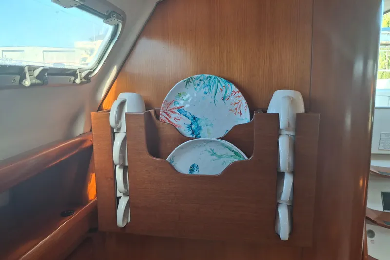 H2o Bungalow Yacht Photos Pics Wooden dish rack with colorful plates on a 2006 Beneteau Oceanis 393 yacht.