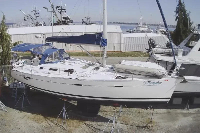 H2o Bungalow Yacht Photos Pics 2006 Beneteau Oceanis 393 sailboat on stands, marina background, blue canopy.
