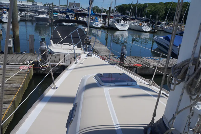 Midnight Yacht Photos Pics Sailboat docked at marina, Sabre 386, 2005 model, surrounded by other boats.