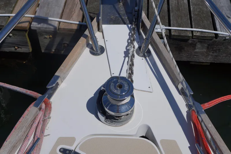 Midnight Yacht Photos Pics Bow of 2005 Sabre 386 sailboat with anchor chain and winch.