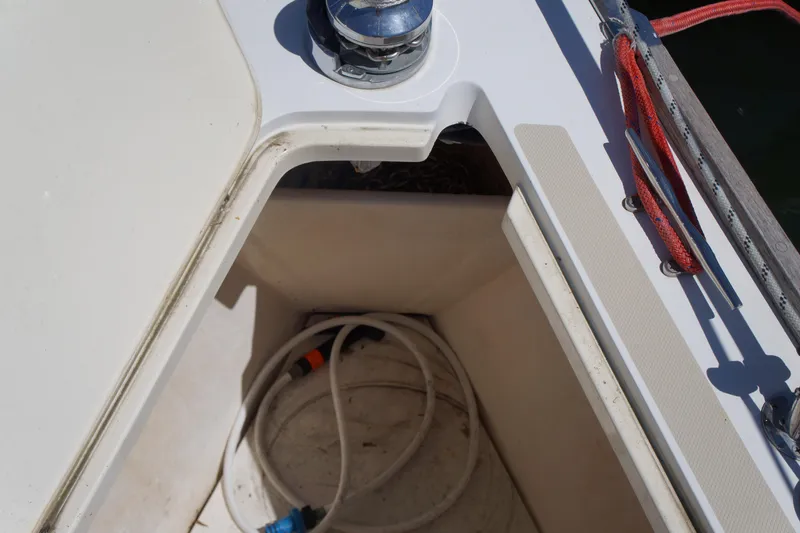 Midnight Yacht Photos Pics Storage compartment on 2005 Sabre 386 sailboat with coiled hose inside.