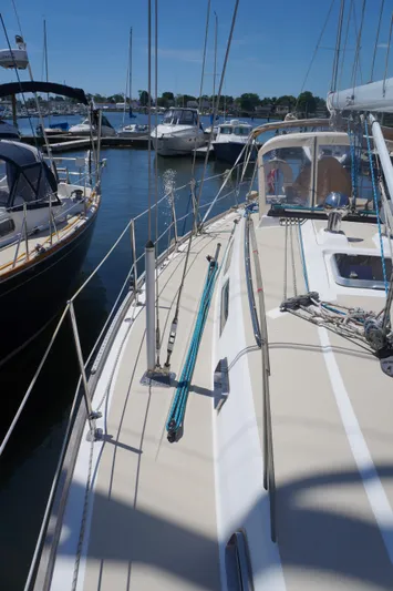 Midnight Yacht Photos Pics 2005 Sabre 386 sailboat docked in a marina under clear blue skies.