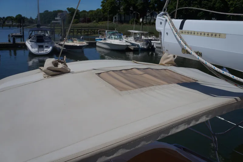 Midnight Yacht Photos Pics A 2005 Sabre 386 sailboat docked, featuring a beige canopy and nearby boats.