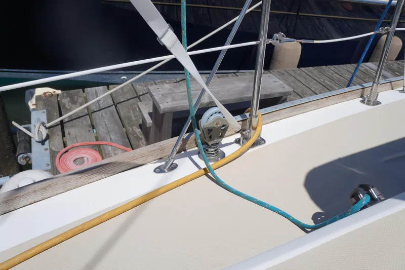 Midnight Yacht Photos Pics Deck of 2005 Sabre 386 sailboat with ropes and dock in view.