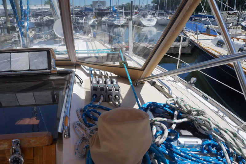 Midnight Yacht Photos Pics Deck view of a 2005 Sabre 386 sailboat with ropes and marina background.