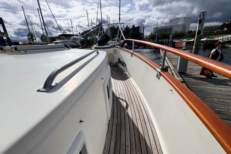 Yacht Photos Pics 1989 Grand Banks 42 yacht docked, showcasing wooden deck and sleek design.