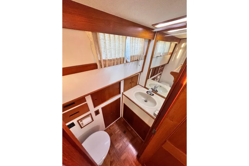  Yacht Photos Pics 1989 Grand Banks 42 yacht bathroom with wood accents and sink.