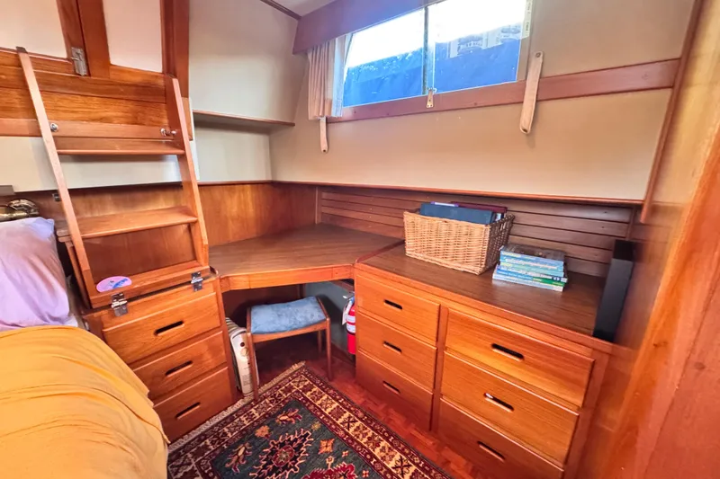  Yacht Photos Pics Cozy cabin interior of 1989 Grand Banks 42 with wooden furniture and nautical decor.