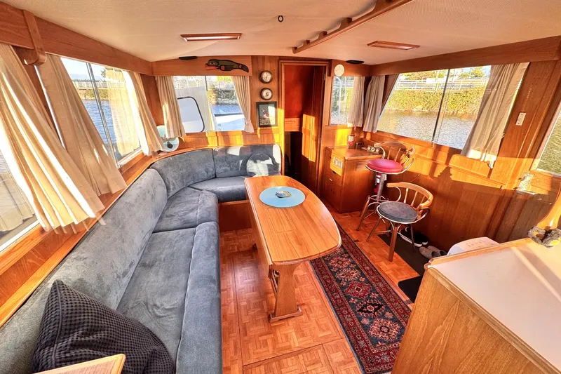  Yacht Photos Pics Interior of 1989 Grand Banks 42 yacht with cozy seating and wooden decor.