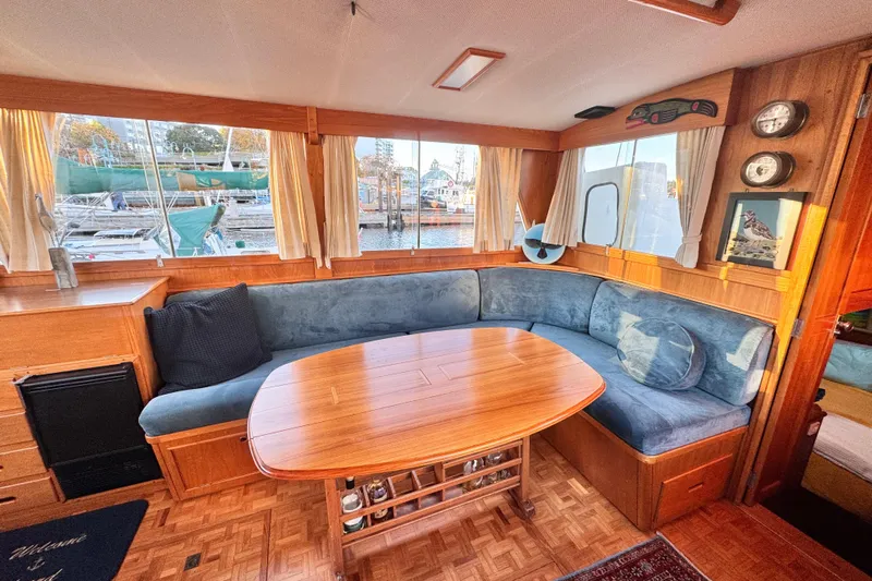  Yacht Photos Pics Interior of 1989 Grand Banks 42 yacht with cozy seating and wooden table.