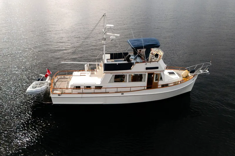  Yacht Photos Pics 1989 Grand Banks 42 yacht on calm water, featuring classic design and spacious deck.