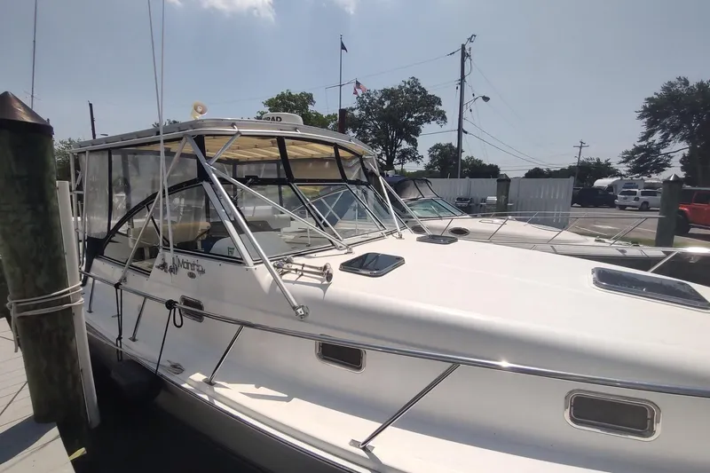 "rosebud" Yacht Photos Pics 2003 Mainship 34 PILOT boat docked at marina under clear sky.