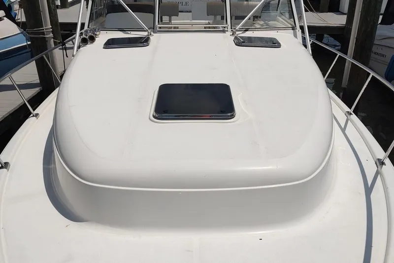 "rosebud" Yacht Photos Pics 2003 Mainship 34 PILOT boat deck with hatch and railing in marina.