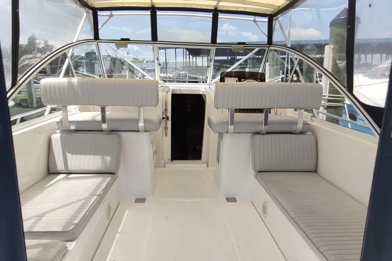 "rosebud" Yacht Photos Pics 2003 Mainship 34 PILOT boat interior with seating and helm, featuring a spacious cockpit.