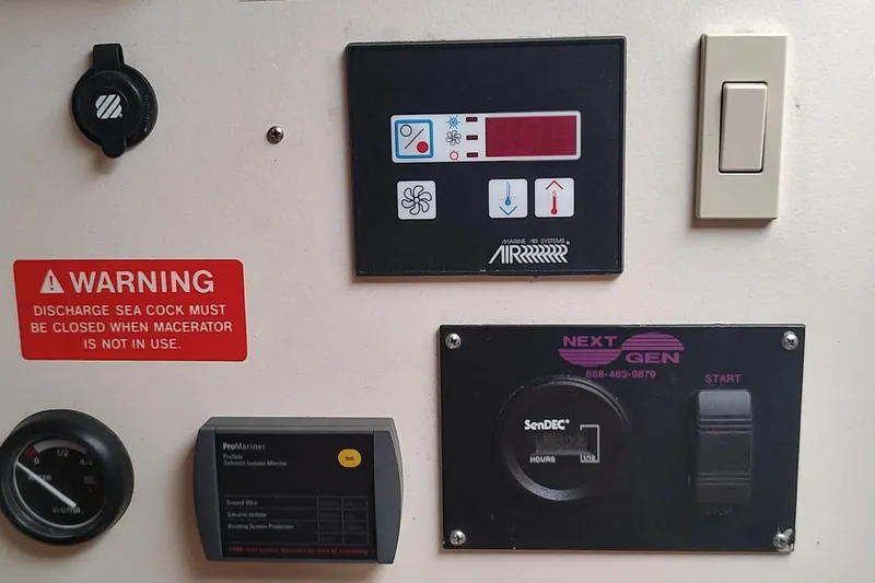 "rosebud" Yacht Photos Pics Control panel of a 2003 Mainship 34 PILOT boat with warning labels and switches.