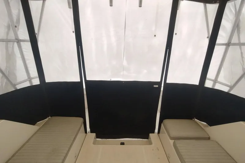 "rosebud" Yacht Photos Pics Interior view of 2003 Mainship 34 PILOT boat with cushioned seating and protective canopy.