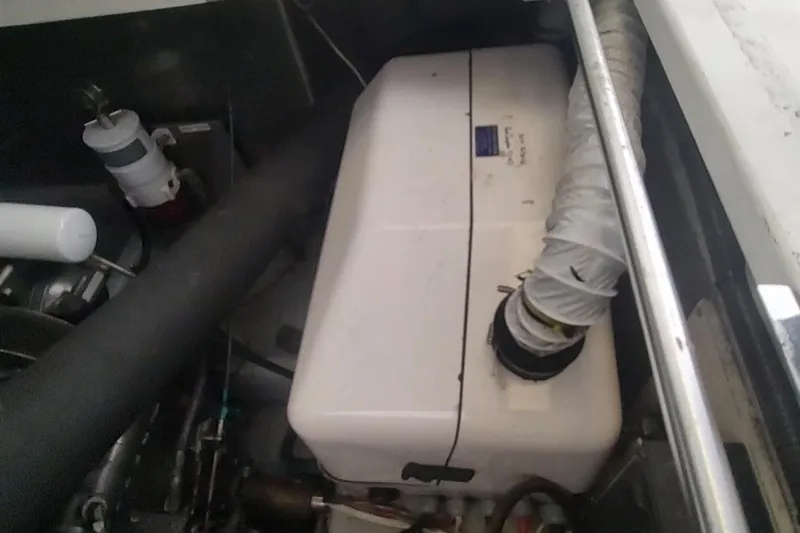 "rosebud" Yacht Photos Pics Engine compartment of a 2003 Mainship 34 PILOT boat, featuring hoses and components.