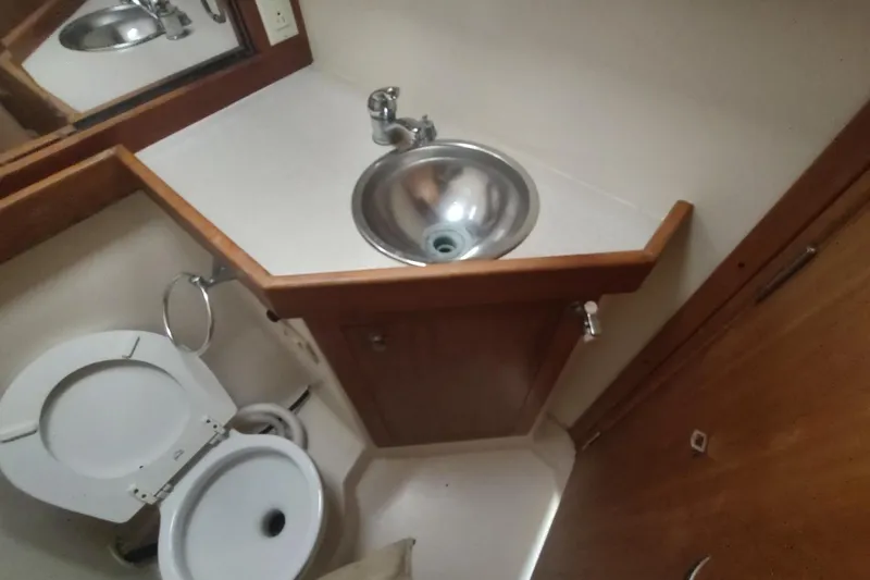 "rosebud" Yacht Photos Pics 2003 Mainship 34 PILOT bathroom with sink and toilet.