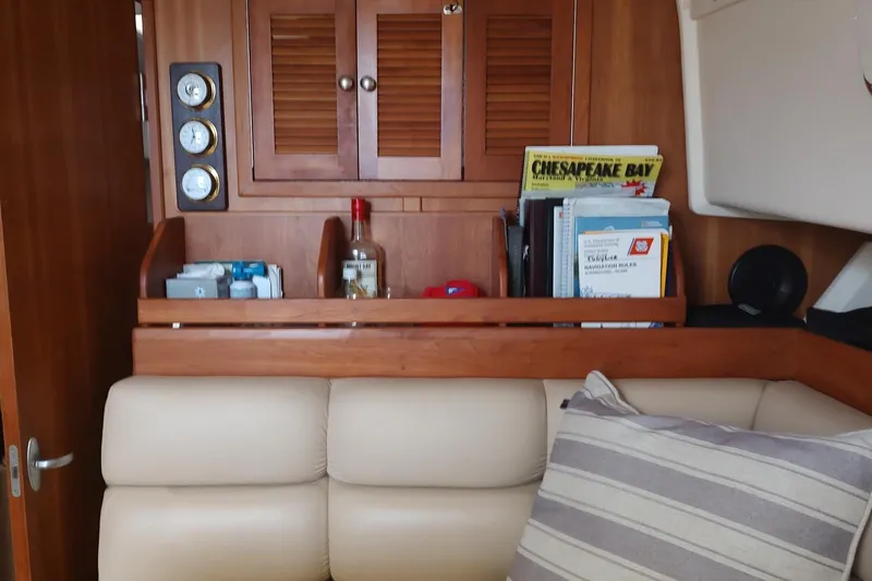 "rosebud" Yacht Photos Pics Interior of 2003 Mainship 34 PILOT with wooden cabinetry and nautical decor.