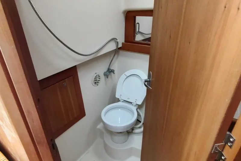 "rosebud" Yacht Photos Pics 2003 Mainship 34 PILOT boat bathroom with toilet and showerhead.