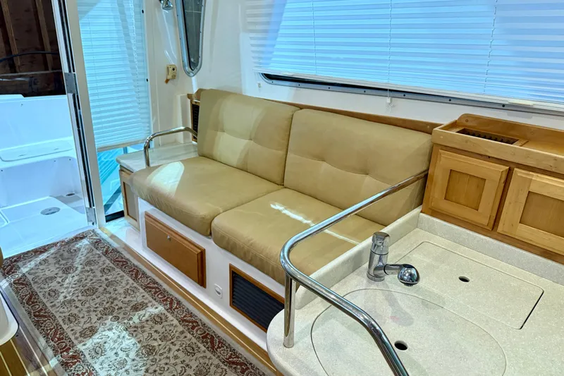 La Dolce Vita Yacht Photos Pics Interior of 2011 Back Cove 37 yacht with beige seating and kitchenette.