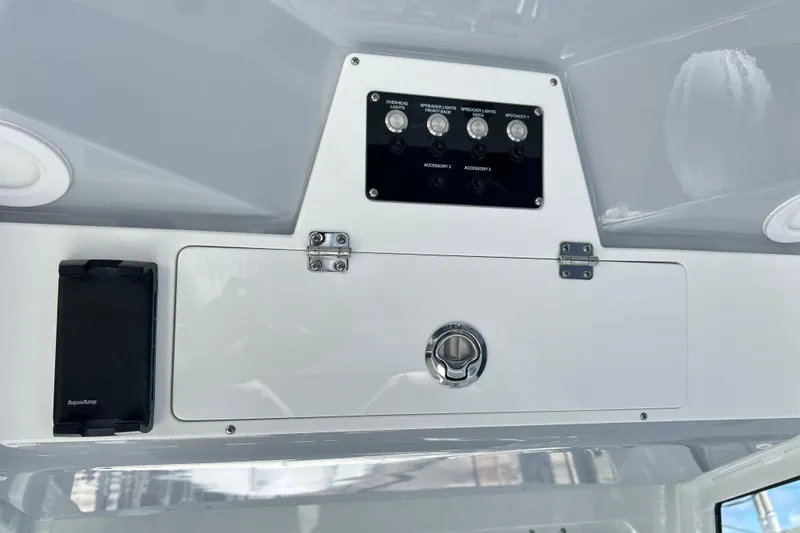  Yacht Photos Pics Control panel of 2026 Sea Fox 268 Commander boat with switches and storage compartment.