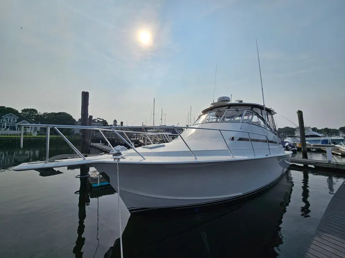 Early Bird Yacht Photos Pics 1998 Ocean Yachts 40 docked under a bright sun, reflecting on calm water.