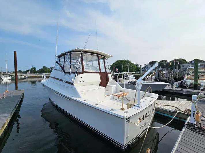 Early Bird Yacht Photos Pics 1998 Ocean Yachts 40 docked at marina, clear sky, calm water.