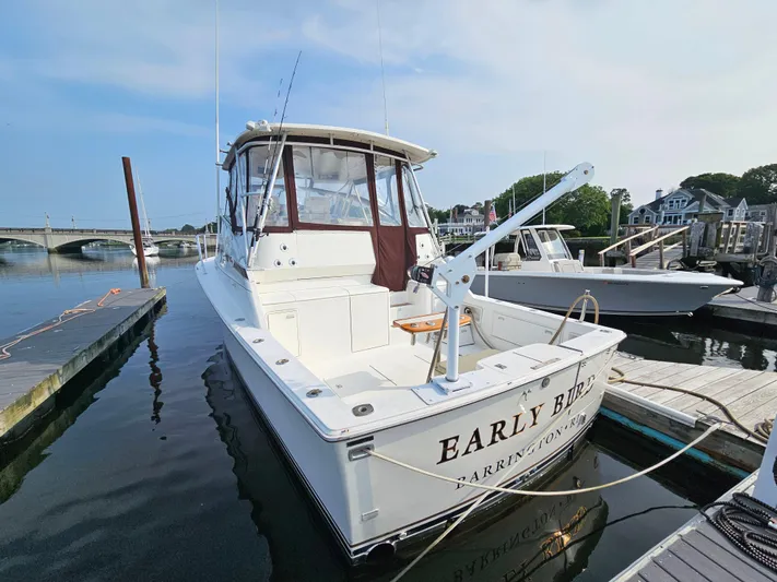 Early Bird Yacht Photos Pics 1998 Ocean Yachts 40 docked at marina, featuring spacious deck and fishing equipment.