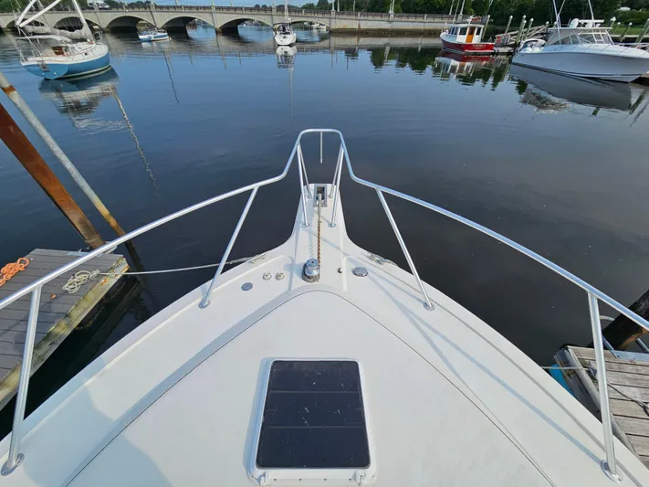 Early Bird Yacht Photos Pics Bow view of 1998 Ocean Yachts 40 at a marina with calm waters.