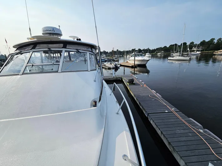 Early Bird Yacht Photos Pics Ocean Yachts 40, 1998 model, docked at a serene marina with calm waters.