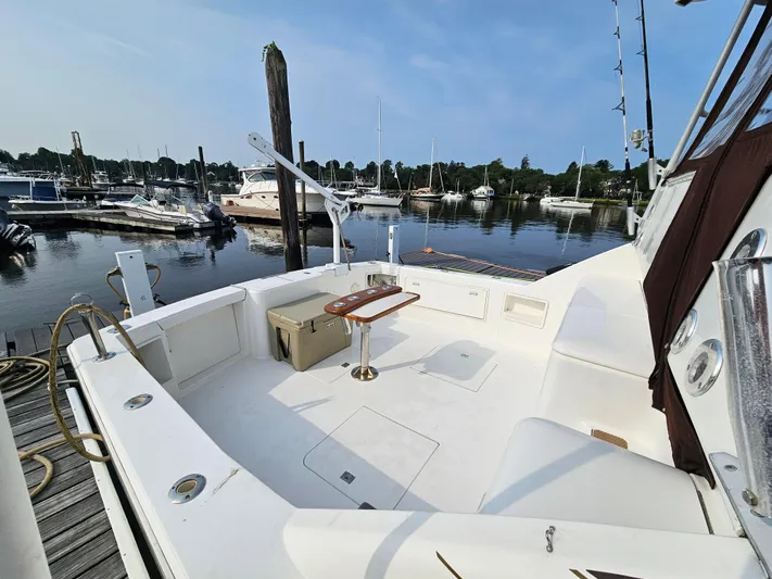 Early Bird Yacht Photos Pics 1998 Ocean Yachts 40 docked at a marina, featuring spacious deck and seating area.
