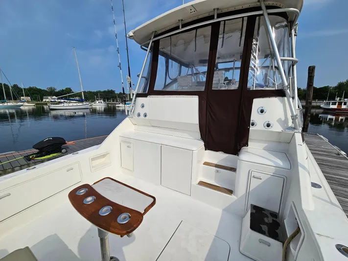 Early Bird Yacht Photos Pics 1998 Ocean Yachts 40 boat with spacious deck and fishing rod holders at marina.