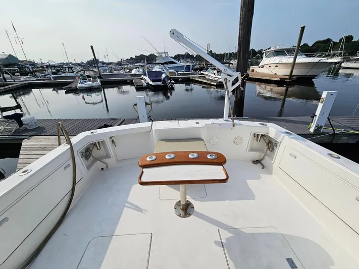 Early Bird Yacht Photos Pics 1998 Ocean Yachts 40 at marina, featuring spacious deck and fishing rod holders.