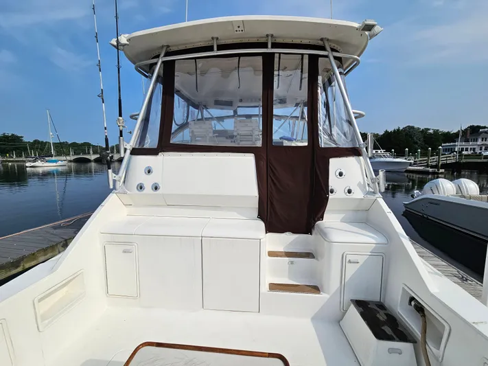 Early Bird Yacht Photos Pics 1998 Ocean Yachts 40 boat with enclosed cockpit, docked at a marina.