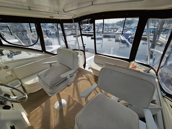 Early Bird Yacht Photos Pics 1998 Ocean Yachts 40 interior with seating, overlooking marina through large windows.