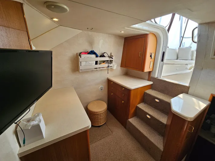 Early Bird Yacht Photos Pics Interior of 1998 Ocean Yachts 40, featuring stairs, cabinets, and a TV.