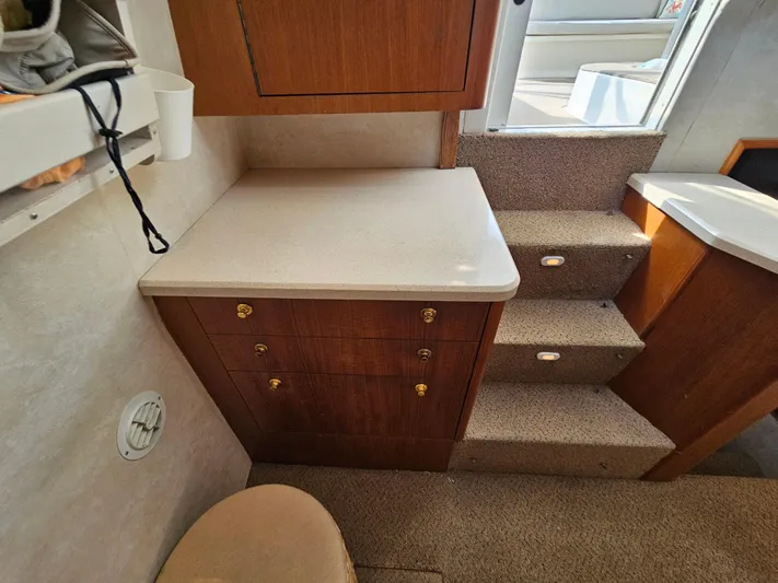 Early Bird Yacht Photos Pics Interior of 1998 Ocean Yachts 40, featuring wooden cabinetry and carpeted stairs.