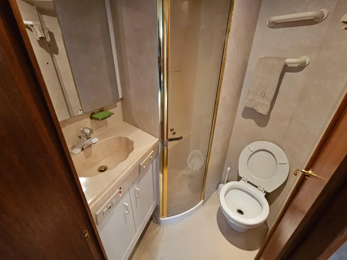 Early Bird Yacht Photos Pics Bathroom interior of 1998 Ocean Yachts 40, featuring shower, sink, and toilet.