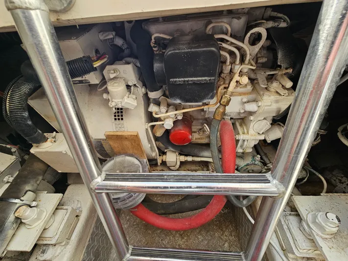 Early Bird Yacht Photos Pics Engine compartment of a 1998 Ocean Yachts 40, featuring mechanical components and hoses.