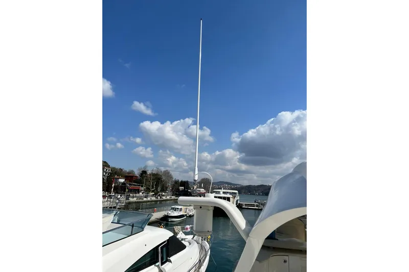  Yacht Photos Pics 2008 Marquis 690 Fly yacht docked under a clear blue sky.