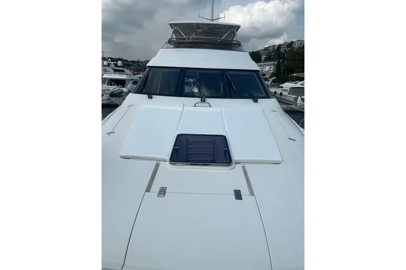  Yacht Photos Pics 2008 Marquis 690 Fly yacht docked, showcasing sleek design and spacious deck.