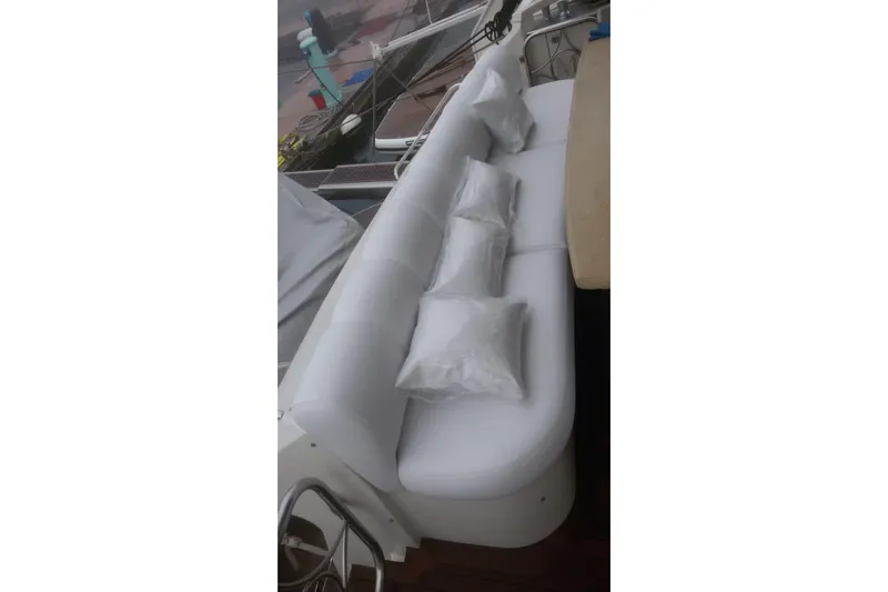  Yacht Photos Pics White cushioned seating area on 2008 Marquis 690 Fly yacht deck.