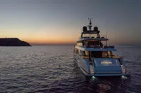 Luxurious 2020 Custom Line Navetta 33 yacht at sunset on open sea.